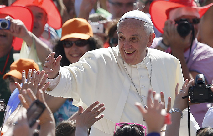Pope Francis greets the crowd as he arrives to lead his general audience in St. Peter's Square at the Vatican June 19. (CNS photo/Paul Haring)