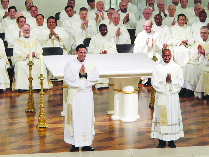 Father Jorge Ivan Asencio Micheli (left) and Father Charles Mwaniki Githinji smile as they are welcomed into the priesthood. The Rite of Ordination to the Priesthood was celebrated by Bishop Kevin Farrell, on June 01, 2013 at the Cathedral Shrine of the Virgin of Guadalupe in Downtown Dallas. (Ben Torres/Special Contributor)