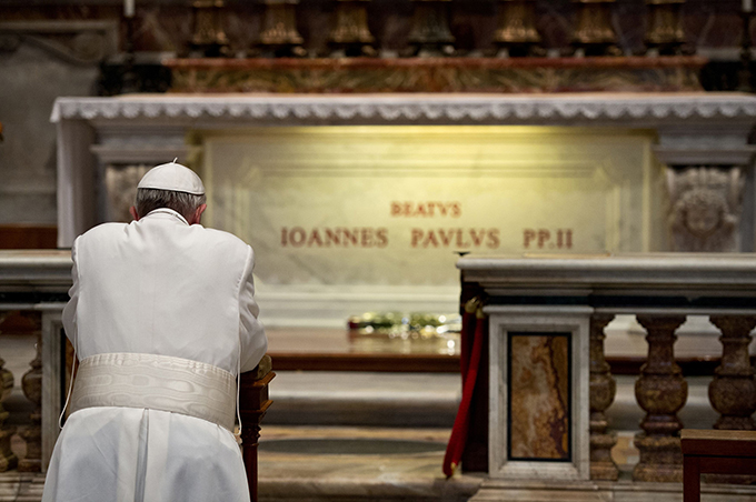 Pope Francis prays in front of the tomb of the late Blessed John Paul II in St. Peter's Basilica at the Vatican April 2, the eighth anniversary of his death. (CNS photo/L'Osservatore Romano via Reuters)