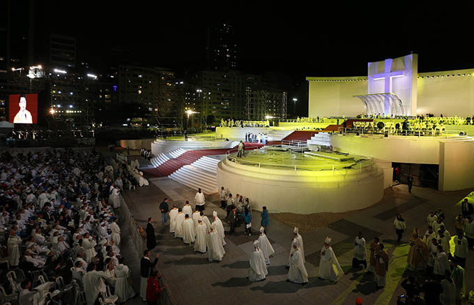 Bishops arrive for the opening ceremony of World Youth Day in Rio de Janeiro July 23. Pilgrims endured rain and wind on Copacabana beach as they gathered for the event's kickoff and opening Mass. (CNS photo/Paul Haring)