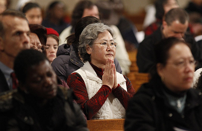 A woman prays at the Basilica of the National Shrine of the Immaculate Conception in Washington.(CNS photo/Bob Roller)