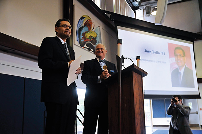 President Michael Earsing, at right, introduces José Tello, winner of the Distinguished Alumnus of the Year Award, during a special assembly at Jesuit College Preparatory School Oct. 18. (Jenna Teter/Texas Catholic)