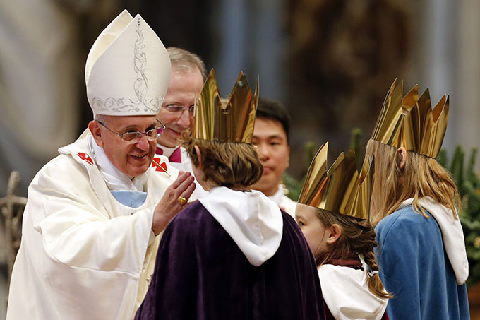 Children bring Pope Francis chalice during offertory during Mass at St. Peter's Basilica Jan. 1
