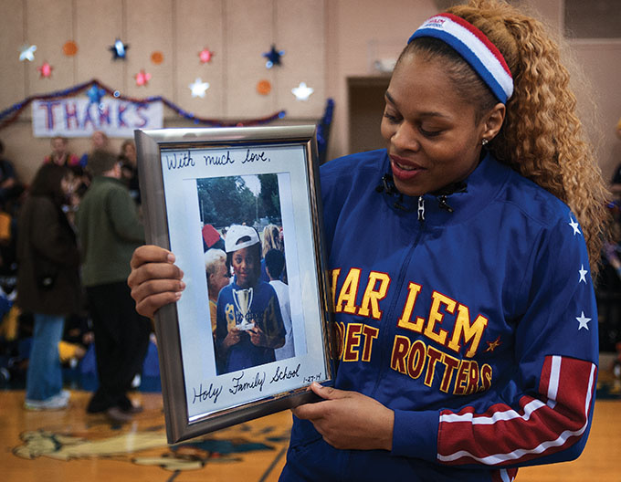 Joyce "Sweet J" Ekworomadu is presented with an old picture of herself as a 5th grader at Holy Family of Nazareth Catholic School in Irving Jan. 27. (JENNA TETER/The Texas Catholic)