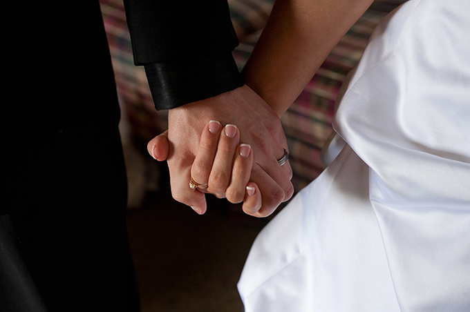 A groom and bride hold hands on their wedding day.  (CNS file photo/Jon L. Hendricks)
