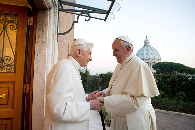 Retired Pope Benedict XVI greets Pope Francis at the Mater Ecclesiae monastery at the Vatican Dec. 23. The monastery, located in the Vatican Gardens to the north of St. Peter's Basilica, is where Pope Benedict is living. (CNS photo/L'Osservatore Romano via Reuters)