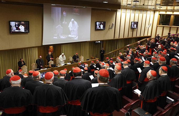 Pope Francis leads opening prayer during a meeting of cardinals in the synod hall at the Vatican Feb. 20. The pope asked the world's cardinals and those about to be made cardinals to meet at the Vatican Feb. 20-21 to discuss the church's pastoral approach to the family. (CNS photo/Paul Haring)
