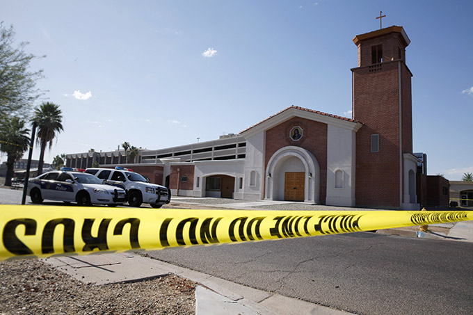 Police tape and vehicles are seen outside Mater Misericordiae (Mother of Mercy) Mission in Phoenix the morning after a priest was killed and another critically injured during an attack at the mission the night of June 11. Sgt. Steve Martos of the Phoenix Police Department said police received a 911 call at about 9 p.m. reporting a burglary. (CNS photo/Nancy Wiechec)