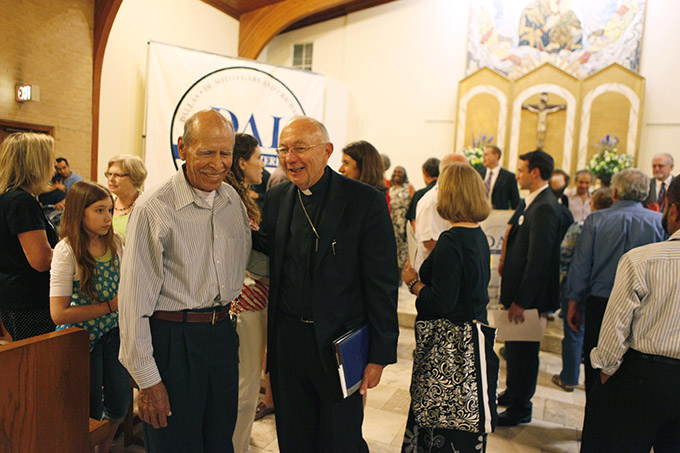 Auxiliary Bishop J. Douglas Deshotel visits with Jesus Esparza, a parishioner of San Juan Diego Catholic Church, after Bishop Deshotel spoke during a prayer vigil and rally for immigration reform, coordinated by Dallas Area Interfaith, on  June 18 at Our Lady of Perpetual Help Catholic Church in Dallas. (BEN TORRES/Special Contributor)