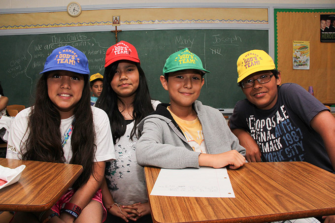 From left, Molly Cabrera, Daniela Rodriguez, Mauricio Fernandez and Mario Rodriguez get into the spirit with their “God’s Team” attire during Vacation Bible School at Holy Cross Catholic Church in Oak Cliff on June 27. According to organizers, the VBS saw a jump in participation this year thanks in part to a move from daytime to evening hours. (MICHAEL GRESHAM/The Texas Catholic)