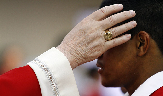 Bishop Kevin J. Farrell anoints a young catholic during a Mass of Confirmation at Corpus Christi Catholic Church June 21 in Ferris. (Ben Torres/Special Contributor)