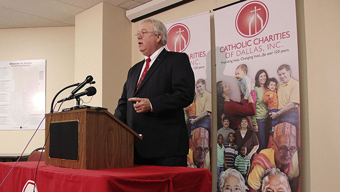Catholic Charities CEO Arne Nelson opens a news conference Nov. 21 to update the media about how President Obama's would affect the Dallas nonprofit.