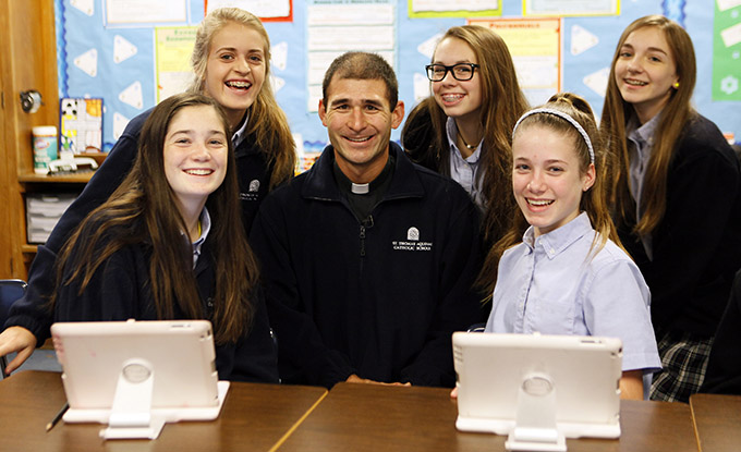 Father James Yamauchi visits with eighth-graders at St. Thomas Aquinas Catholic School, on Dec. 10. (BEN TORRES/Special Contributor)