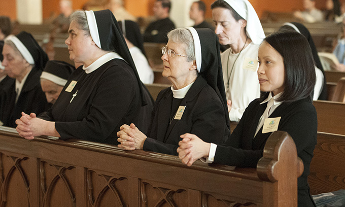 A group of nuns kneels in prayer during the Mass Celebration of Consecrated Life in the Church at the Cathedral Shrine of the Virgin of Guadalupe on Feb. 14. (JENNA TETER/The Texas Catholic)