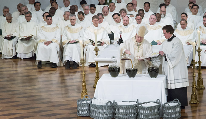 Bishop Kevin J. Farrell mixes the oil of Chrism during the Chrism Mass at the Cathedral Shrine of the Virgin of Guadalupe in Dallas, Tuesday, April 15, 2014. (RON HEFLIN/Special Contributor)