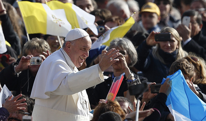 Pope Francis greets the crowd as he arrives to lead his general audience in St. Peter's Square at the Vatican March 4. (CNS photo/Paul Haring)