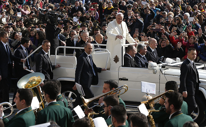 Pope Francis passes a band as he arrives to lead his general audience in St. Peter's Square at the Vatican March 11. (CNS photo/Paul Haring)