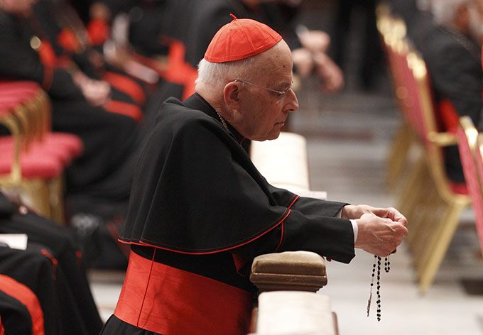 Cardinal Francis E. George of Chicago prays the rosary before a prayer service with eucharistic adoration in St. Peter's Basilica at the Vatican in 2013.  Cardinal George, 78, died April 17 after a long battle with cancer. (CNS photo/Paul Haring)