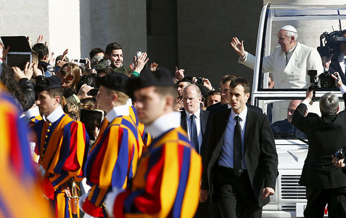 Pope Francis waves as he arrives to lead his weekly audience in St. Peter's Square at the Vatican April 8. (CNS photo/Tony Gentile, Reuters)