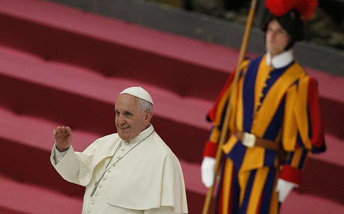 A Swiss Guard is pictured as Pope Francis greets the crowd during an audience  at the Vatican May 8. (CNS photo/Paul Haring)