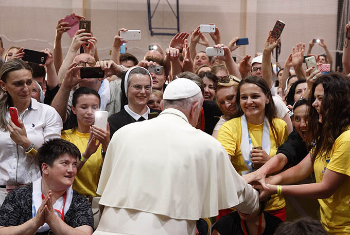 Pope Francis greets young people during a meeting with them at the diocesan John Paul II Youth Center in Sarajevo, Bosnia-Herzegovina, June 6. The pope made a one-day visit to Bosnia-Herzegovina to encourage a minority Catholic community in the faith and to foster dialogue and peace in a nation still largely divided along ethnic lines. (CNS photo/Paul Haring)