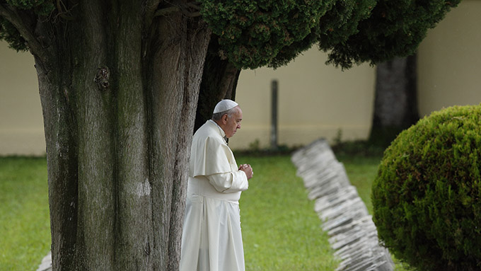 Pope Francis is shown praying at an Austro-Hungarian cemetery for fall soldiers of World War I in Fogliano di Redipuglia, northern Italy, Sept. 13, 2014. The pope in his encyclical "Laudato Si', on Care for Our Common Home," released June 18, said all creation is singing God's praise but people are silencing it. (CNS photo/Paul Haring)