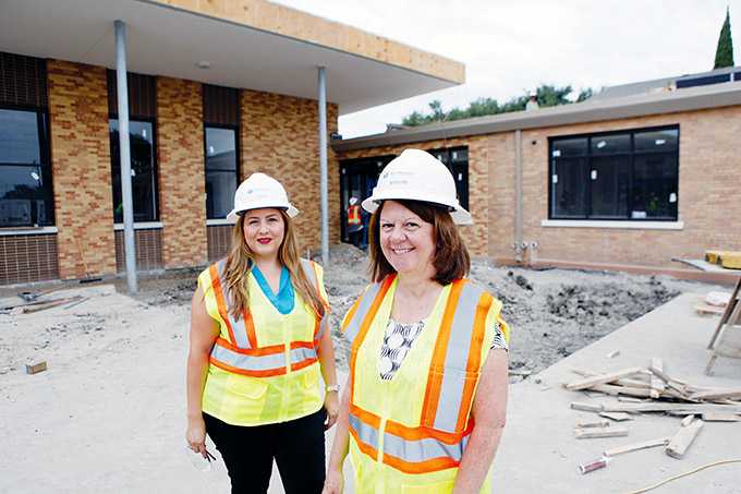 Principal Erica Romero, left, and President Marian Davis tour the ongoing construction of St. Philip & St. Augustine Catholic Academy in Pleasant Grove on Aug. 11. (BEN TORRES/Special Contributor)