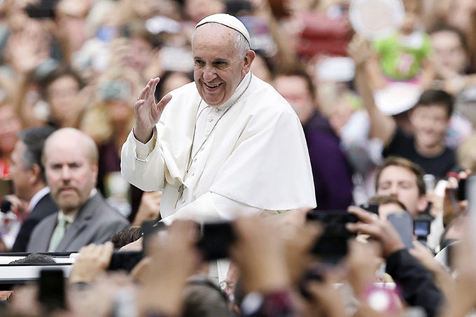 Pope Francis waves to the crowd as he makes his way to celebrate the closing Mass of the World Meeting of Families in Philadelphia Sept. 27.