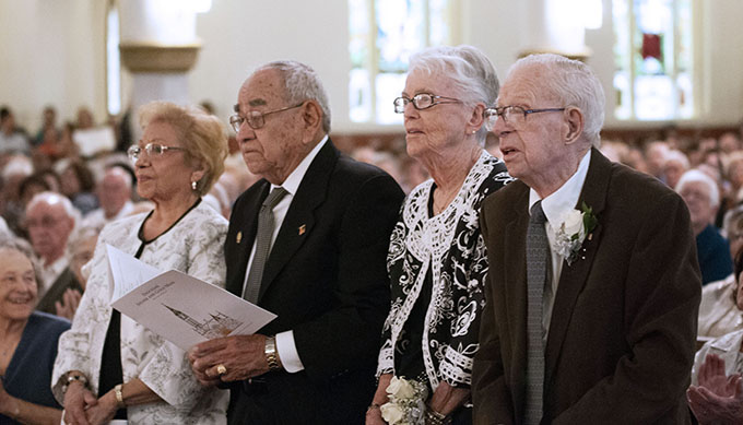 Beatrice and Albert Vera, from left, and Sally and Edward Pendergast stand and are recognized for their 70 years of marriage at the Diocesan Silver and Gold Mass. (JENNA TETER/The Texas Catholic)