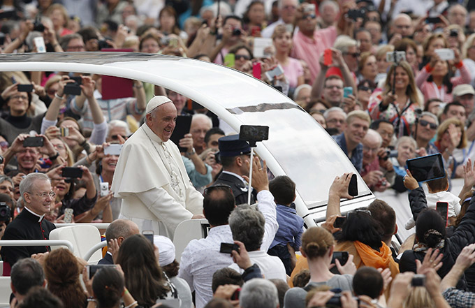 Pope Francis greets the crowd during his general audience in St. Peter's Square at the Vatican Oct. 14. (CNS photo/Paul Haring)