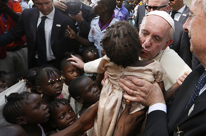 Pope Francis kisses a child as he visits a refugee camp in Bangui, Central African Republic, Nov. 29. (CNS photo/Paul Haring)