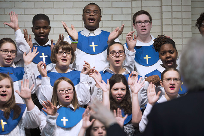 The choir at The Notre Dame School performs Christmas Carols for parents and shoppers in the Dillard’s Plaza at Northpark Mall on Dec. 1. (JENNA TETER/The Texas Catholic)