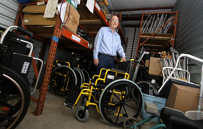Bishop’s Award for Service recipient John Blanks is surrounded by some of the wheelchairs and mobility devices he refurbishes in Garland on Jan. 14. Blanks has two storage units filled with wheelchairs, walkers, crutches and other devices awaiting repair and distribution. (KEVIN BARTRAM/Special Contributor)