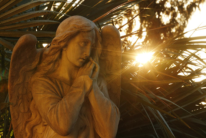 Sun backlights a decorative angel on a tombstone in Verano cemetery in Rome. (CNS photo/Paul Haring)