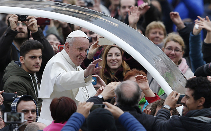 Pope Francis greets the crowd as he arrives to lead his general audience in St. Peter's Square at the Vatican Feb. 3. (CNS photo/Paul Haring)