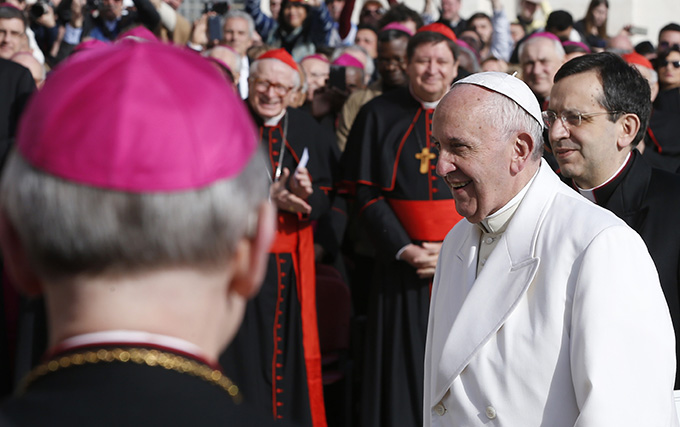Pope Francis walks past cardinals and bishops as he arrives to lead his general audience in St. Peter's Square at the Vatican Feb. 24. (CNS photo/Paul Haring)
