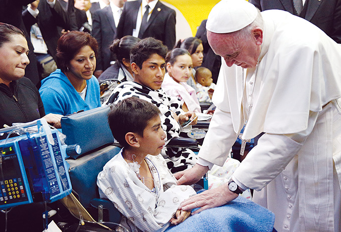 Pope Francis greets a sick child during a visit to the Federico Gomez Children's Hospital of Mexico in Mexico City Feb. 14. (CNS photo/Paul Haring)