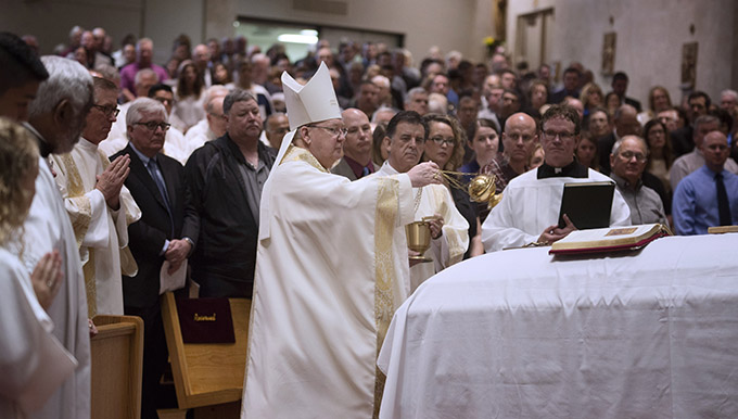 Bishop Kevin J. Farrell incenses the casket of Msgr. Glenn "Duffy" Gardner Jr. at the end of Mass on May 9 at St. Mark the Evangelist Catholic Church in Plano. (JENNA TETER/The Texas Catholic)