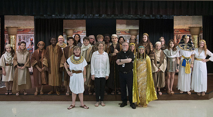 Father Clifford Smith, pastor of St. Mark the Evangelist Catholic Church in Plano, and St. Mark the Evangelist Catholic School Musical Director Patty Corsi with the student-led cast of “Joseph the Dreamer” at the Plano campus on May 11. (JENNA TETER/The Texas Catholic)
