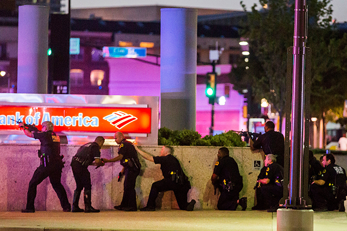 Police respond after shots were fired July 7 during a demonstration in Dallas to protest the police killing of black men in Baton Rouge, La., and a suburb of St. Paul, Minn. Snipers shot and killed five police officers and wounded seven more at the Dallas demonstration. Two civilians also were injured. (CNS photo/Smiley N. Pool, The Dallas Morning News handout via Reuters)