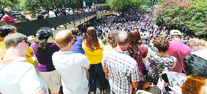 A crowd packs Thanksgiving Square in Dallas for an interfaith prayer vigil July 8. The prior evening a gunman shot and killed five police officers and wounded seven during a peaceful protest in downtown Dallas. The protest was in reaction to two black men being fatally shot by police officers in Baton Rouge, La., and a suburb of St. Paul, Minn. (CNS photo/Erik Lesser, EPA)