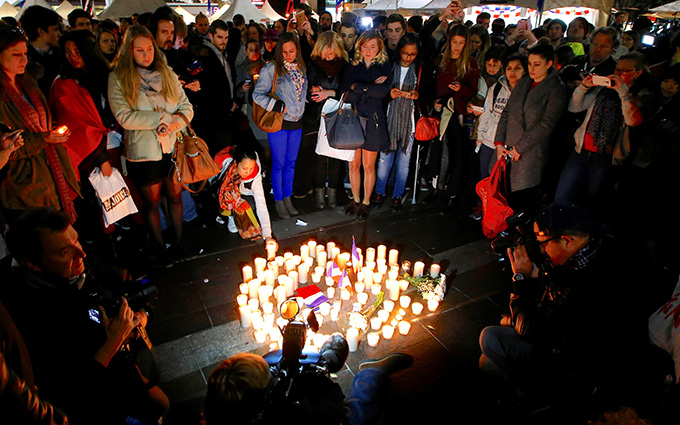 Members of the Australian French community stand around candles during a vigil in central Sydney July 15 to remember the victims of the Bastille Day truck attack in Nice, France. A truck loaded with weapons and hand grenades drove onto a sidewalk in Nice for more than a mile July 14, killing more than 80 people. (CNS photo/David Gray, Reuters)