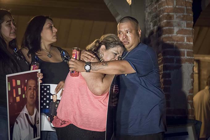 Valerie Zamarripa is hugged by her son Carlos Zamarripa after a candlelight vigil and rosary for her son, Dallas Police Officer Patrick Zamarripa, at Marine Park in Fort Worth, Texas on July 10. (RON HEFLIN/Special Contributor)