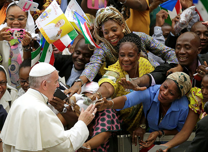 Pope Francis greets the faithful as he arrives to lead his general audience in Paul VI hall at the Vatican Aug. 10. (CNS photo/Max Rossi, Reuters)