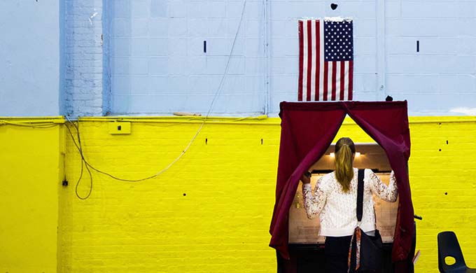 A woman enters a voting booth in Hoboken, N.J., June 7. (CNS photo/Justin Lane, EPA)