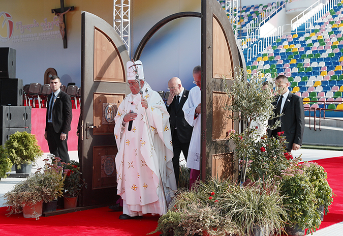 Pope Francis walks through a Holy Door as he arrives to celebrate Mass at Mikheil Meskhi Stadium in Tbilisi, Georgia, Oct. 1. (CNS photo/Paul Haring)