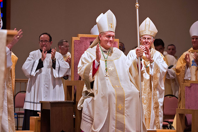 Bishop Robert Coerver receives a standing ovation after being ordained a bishop and installed as the third bishop of Lubbock on Nov. 21 at the Cathedral of Christ the King. (JENNA TETER/The Texas Catholic)
