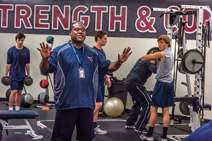 John Paul II football coach George Teague works with the team in the weight room at the school in Plano, Texas, Tuesday, Jan. 10, 2017. (Ron Heflin)