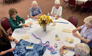 Common thread binds together group crafting baby caps